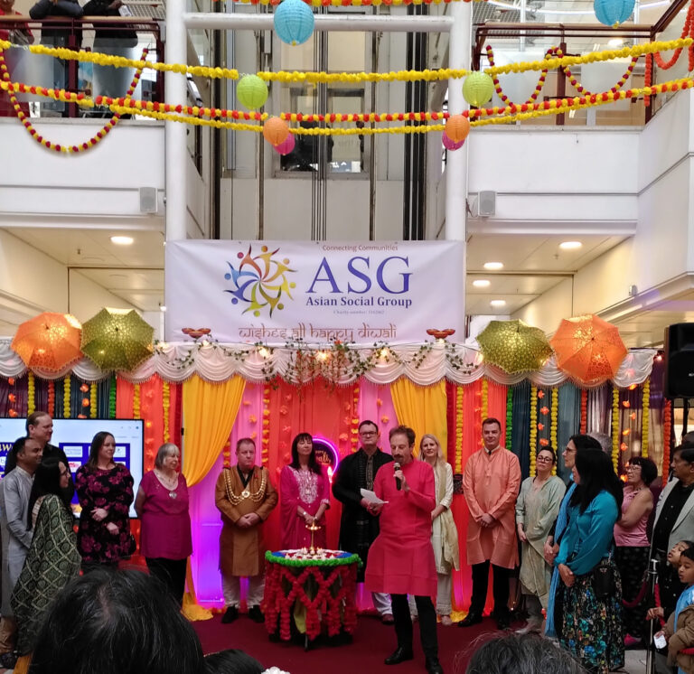 Group of people celebrating Diwali in Redhill's Belfry centre